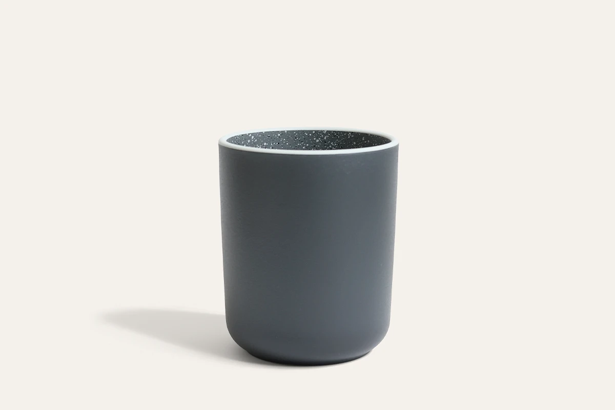 Stoneware-inspired recycled PET tumbler cup with matte black exterior and speckled interior