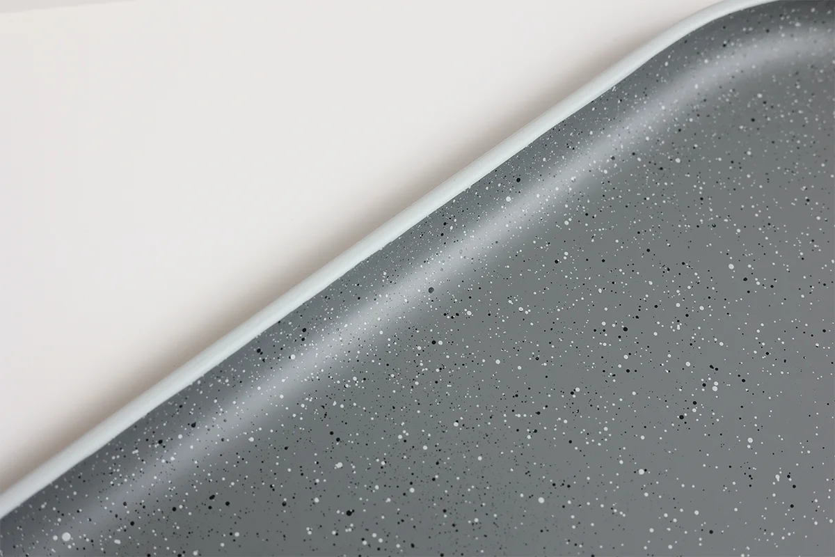 Raised edge detail on stoneware-inspired recycled PET serving tray