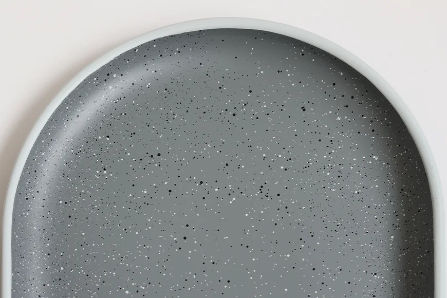 Close-up of speckled stoneware-inspired surface on recycled PET serving tray