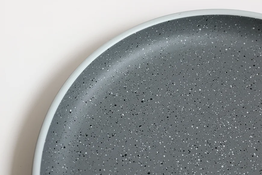Rounded rim detail of stoneware-inspired recycled PET dinner plate