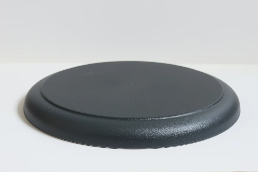 Low-profile side view of stoneware-inspired recycled PET dinner plate
