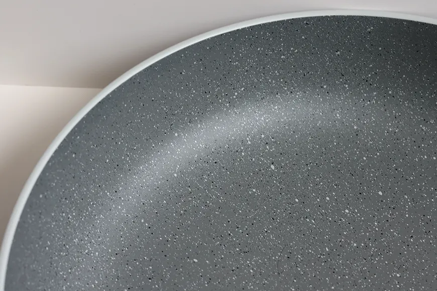 Curved interior detail of stoneware-inspired recycled PET pasta bowl