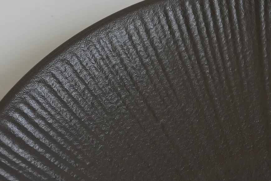 Close-Up of Radiant Texture Pattern on Charcoal Gray Pasta Plate