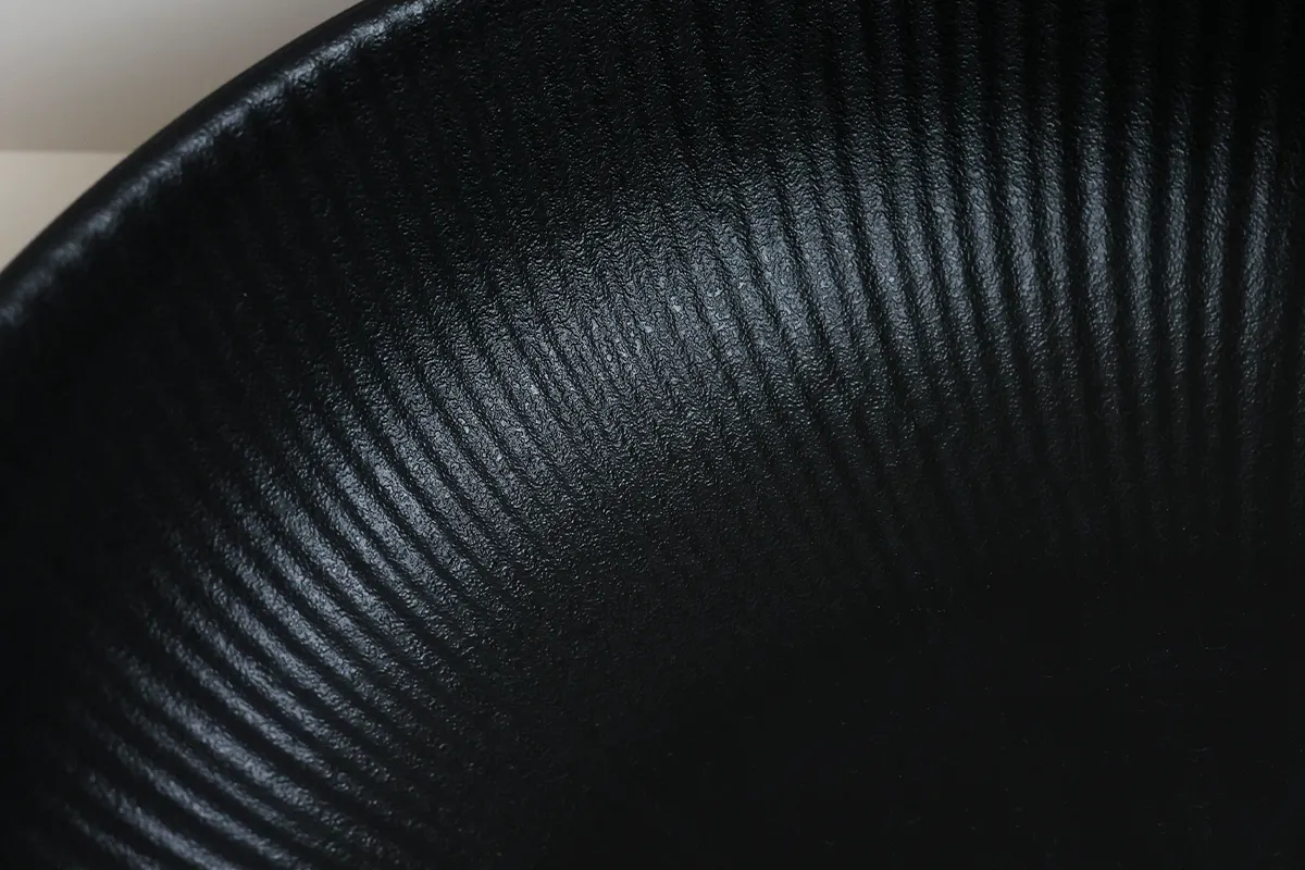 Close-Up of Radiant Texture Pattern on Matte Black Serving Bowl